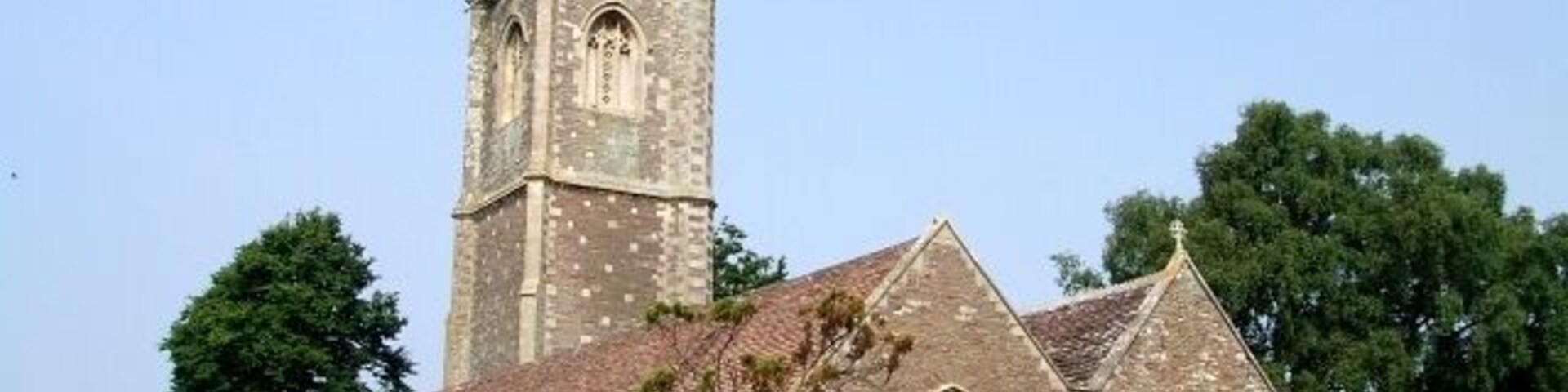 St James the Great, Westerleigh. A gateway from the recreation field to the south of the church into the churchyard, carries the dates "1304 - 2004" - this probably indicates the date of the earliest parts of this church - which I would hazard do not include most of what you see in this picture. The tower in particular looks Victorian to me. What I think is the oldest part of the church can be seen here 464276.