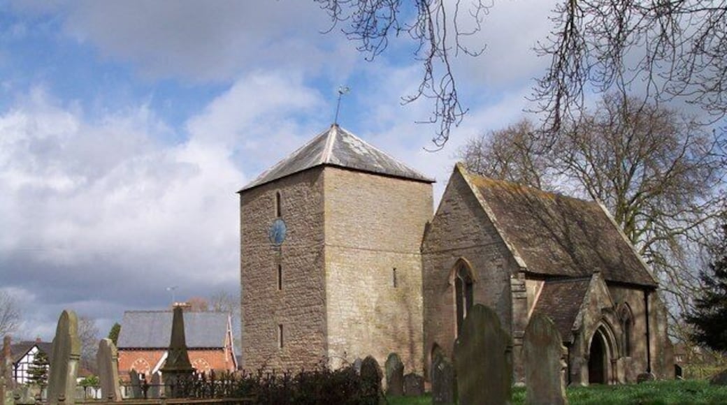 St Bartholomew's parish church, Westhide, Herefordshire. The red brick building behind the obelisk monument is the former village school