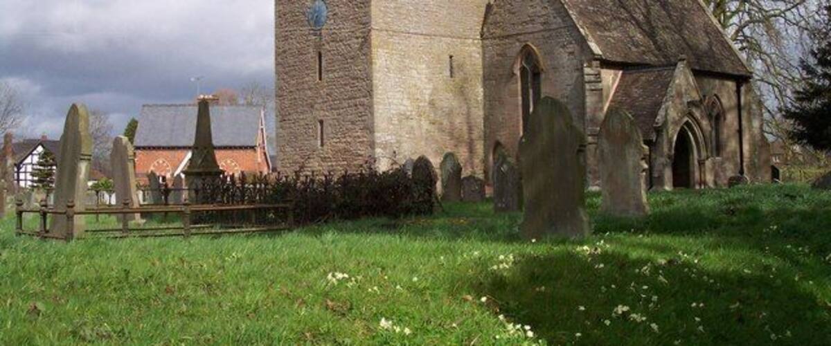 A church with a tower and a graveyard.