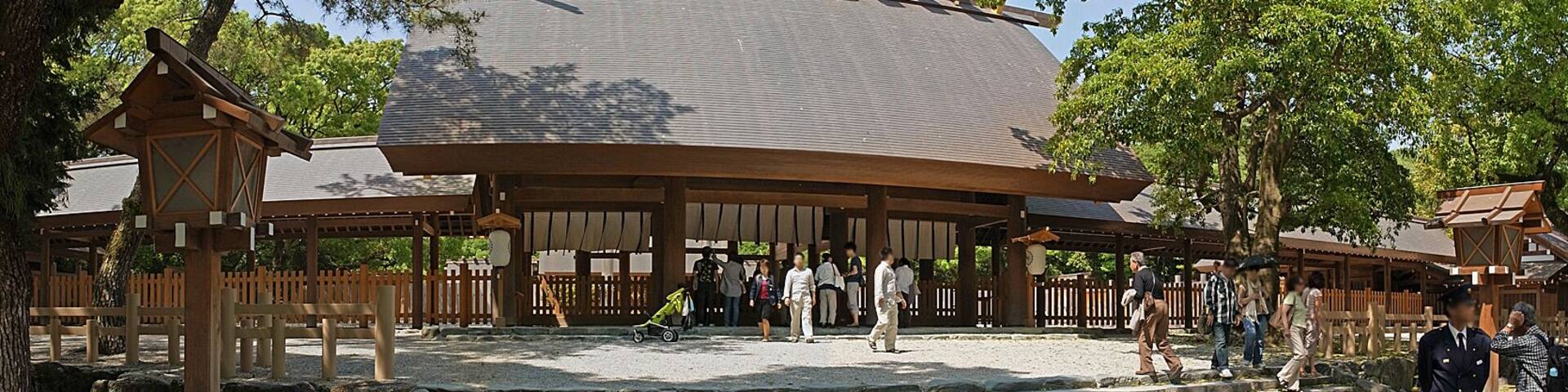 A traditional Japanese temple with a curved roof, wooden structures, and stone steps leading up to the entrance.