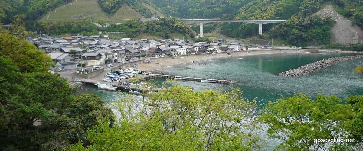 A coastal town with houses, a bridge, and a river.