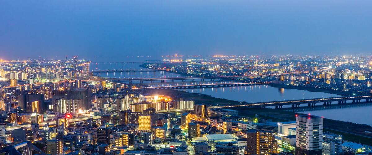 Osaka panorama cityscapes with Yodo river at night. Scenery from Kuchu Teien Observatory on Umeda Sky Building.
