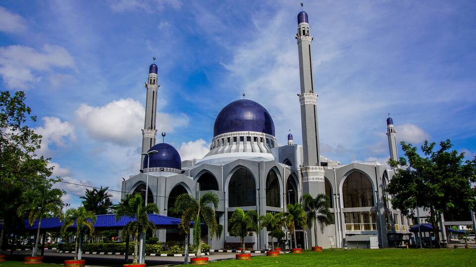 A mosque with two tall minarets and a large central dome.