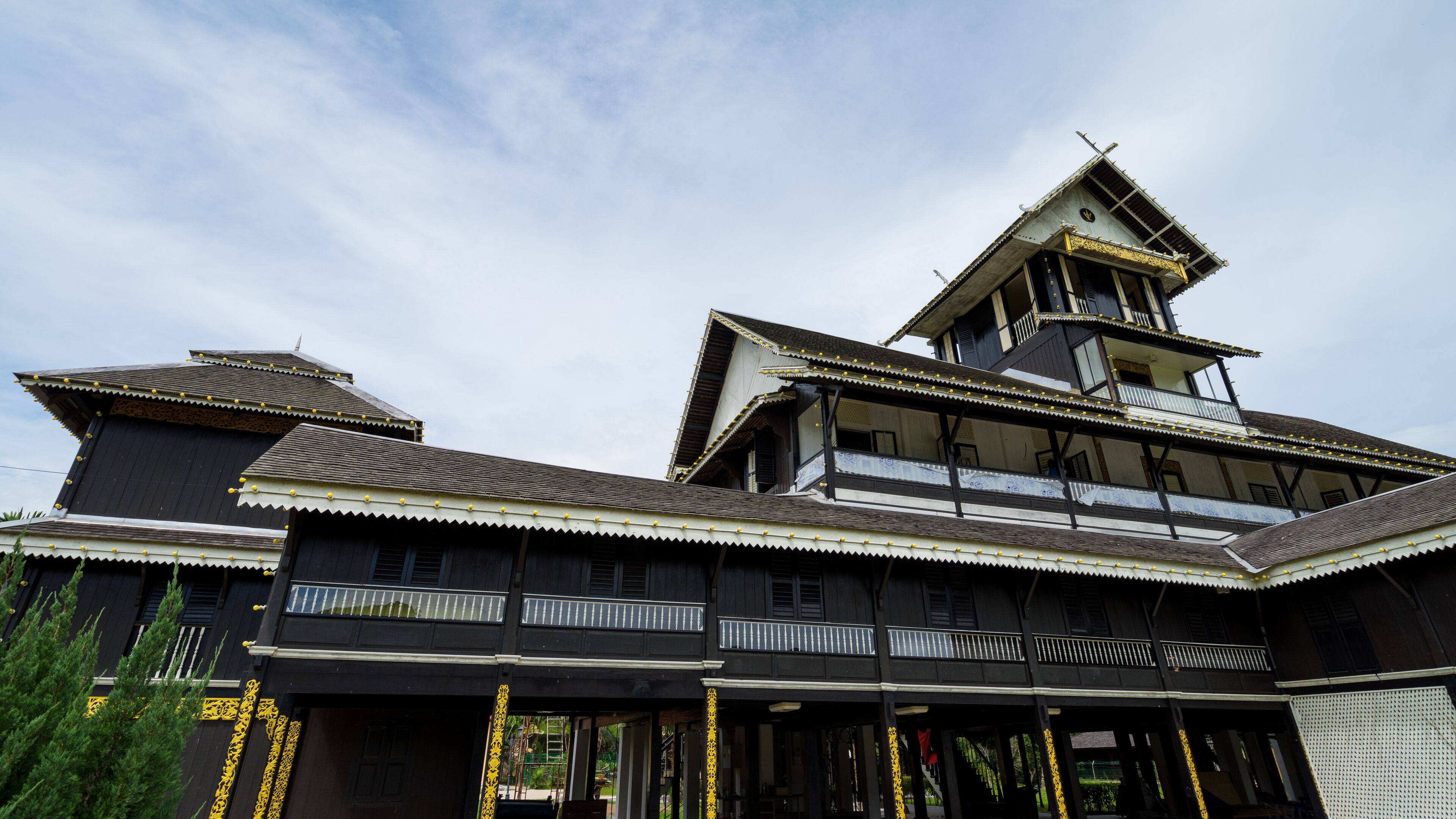 A traditional wooden building with multiple balconies and a steeply pitched roof.