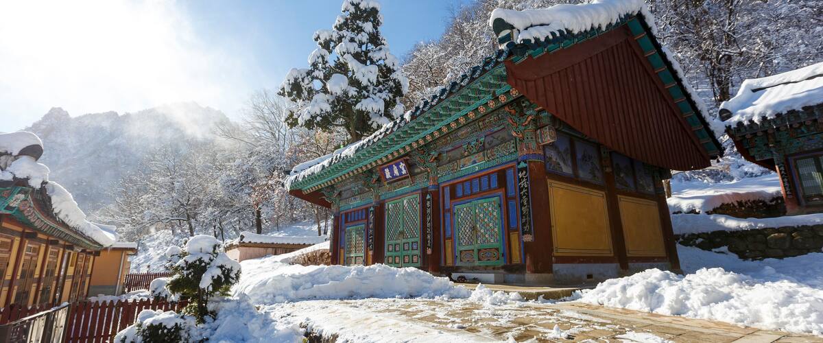 A traditional building with intricate designs and snow-covered surroundings.