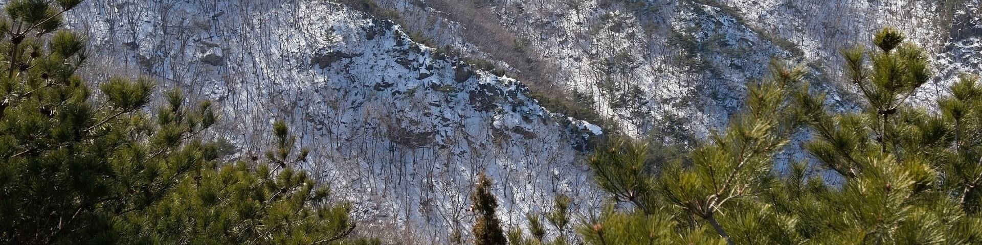 Snow covered rocky Gwanaksan Mountain with weather station at Seoul, South Korea