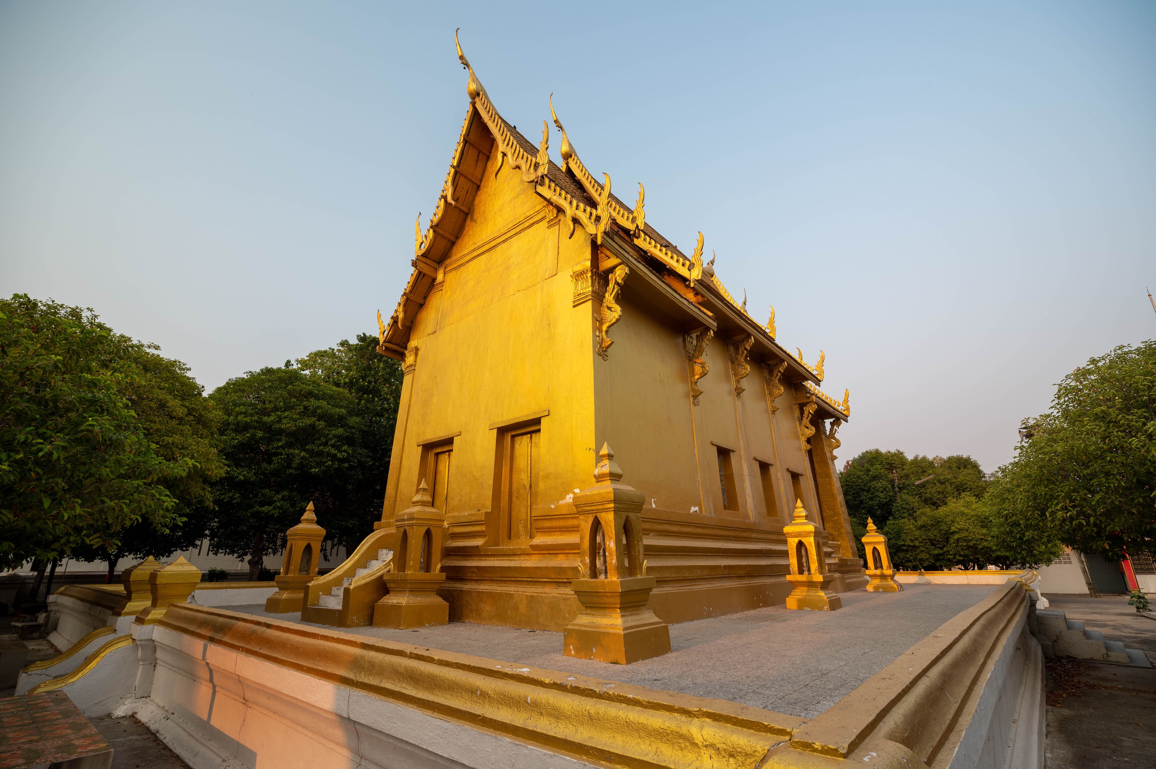 A golden temple with intricate architecture and a clear sky.