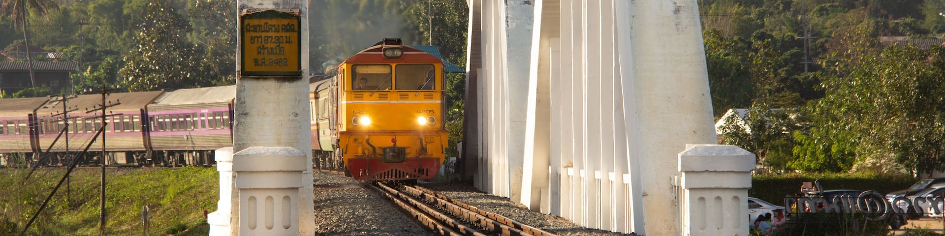Diesel Electric locomotive No.4205 making a procession back to Bangkok crossing a concrete bridge built more than 100 years At Ban Tha Chompoo, Lamphun Province