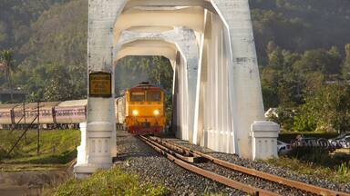 Diesel Electric locomotive No.4205 making a procession back to Bangkok crossing a concrete bridge built more than 100 years At Ban Tha Chompoo, Lamphun Province