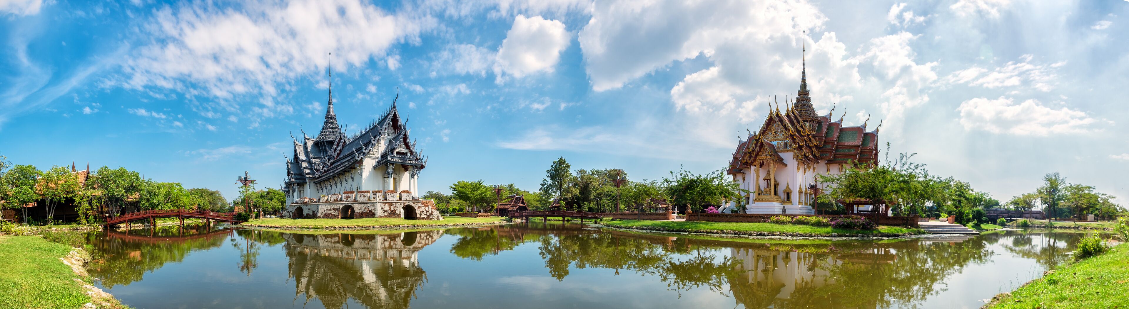 A traditional temple with intricate architecture and a reflection in the water.