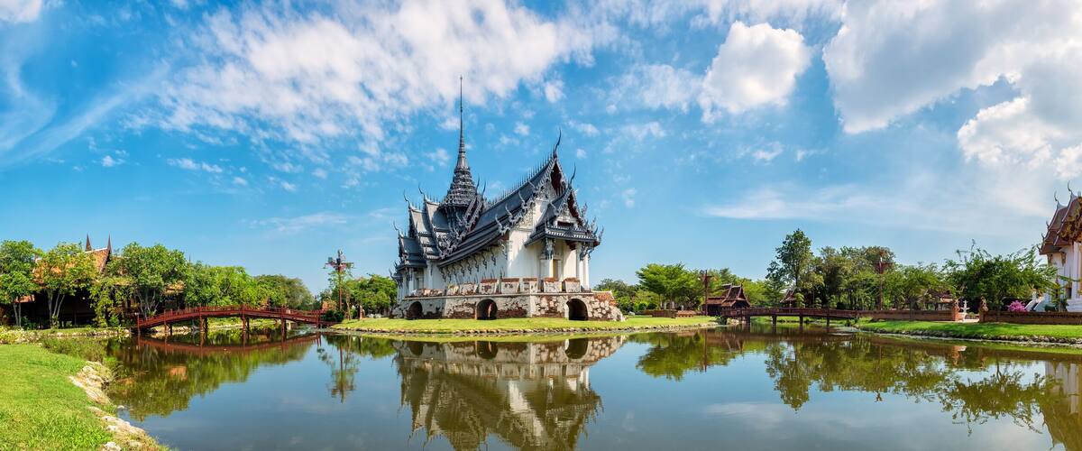 A traditional temple with intricate architecture and a reflection in the water.