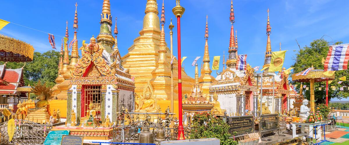 A temple complex with golden spires and statues.