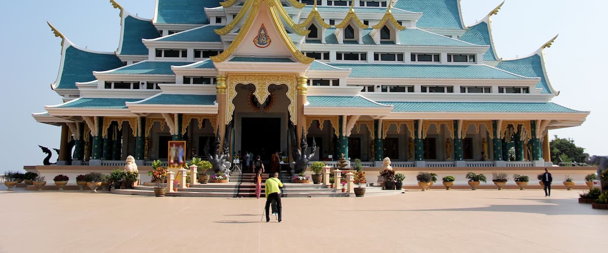 A grand temple with a blue roof and golden accents.