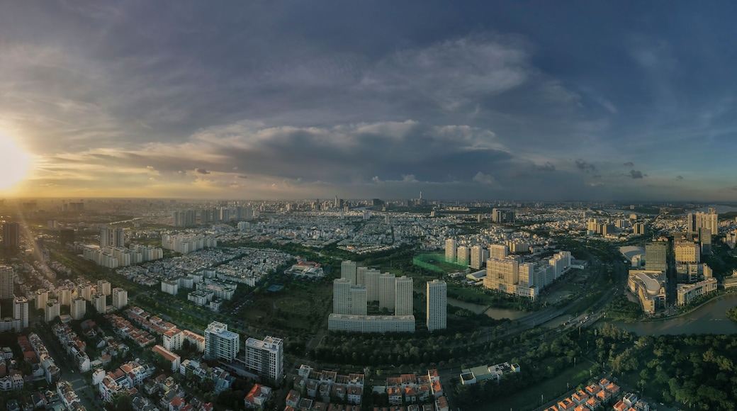 Laaja panoraamanäkymä kaupunkimaisemasta auringonlaskun aikaan, ja näkymässä virtaa joki.