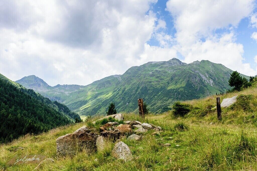 a view on some mountains in the Austrian Alps with some stones in the foreground