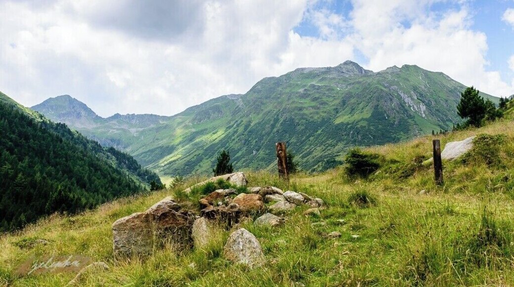 a view on some mountains in the Austrian Alps with some stones in the foreground