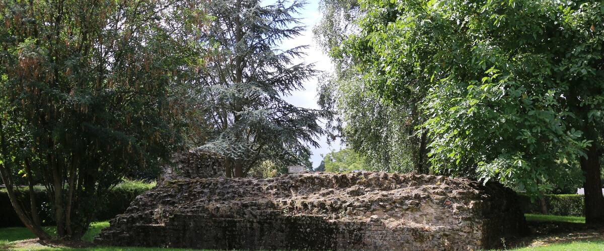 An ancient stone structure surrounded by lush greenery.