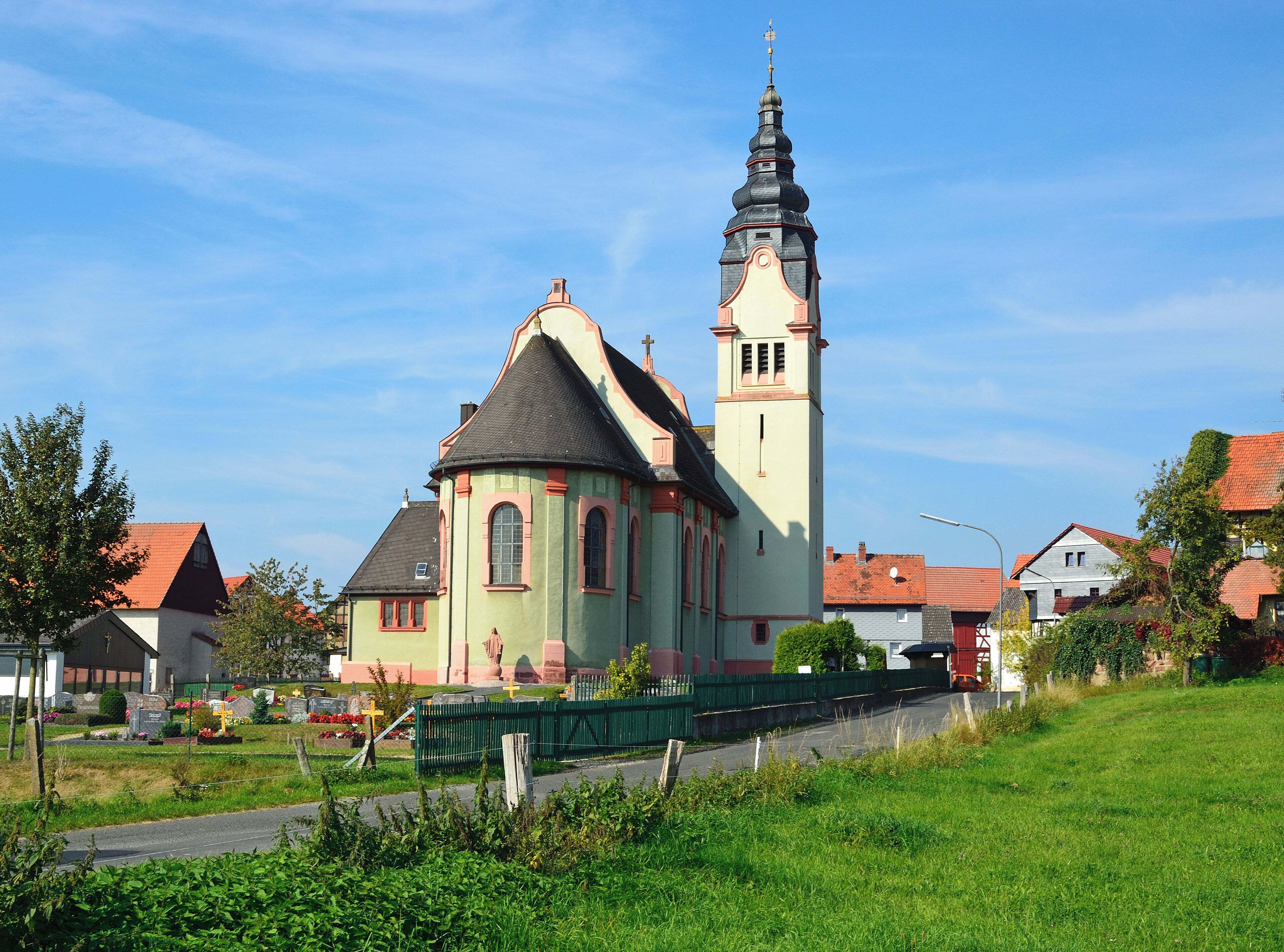 A church with a tall tower and a dome.