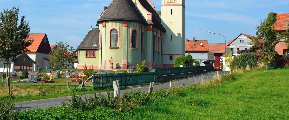 A church with a tall tower and a dome.