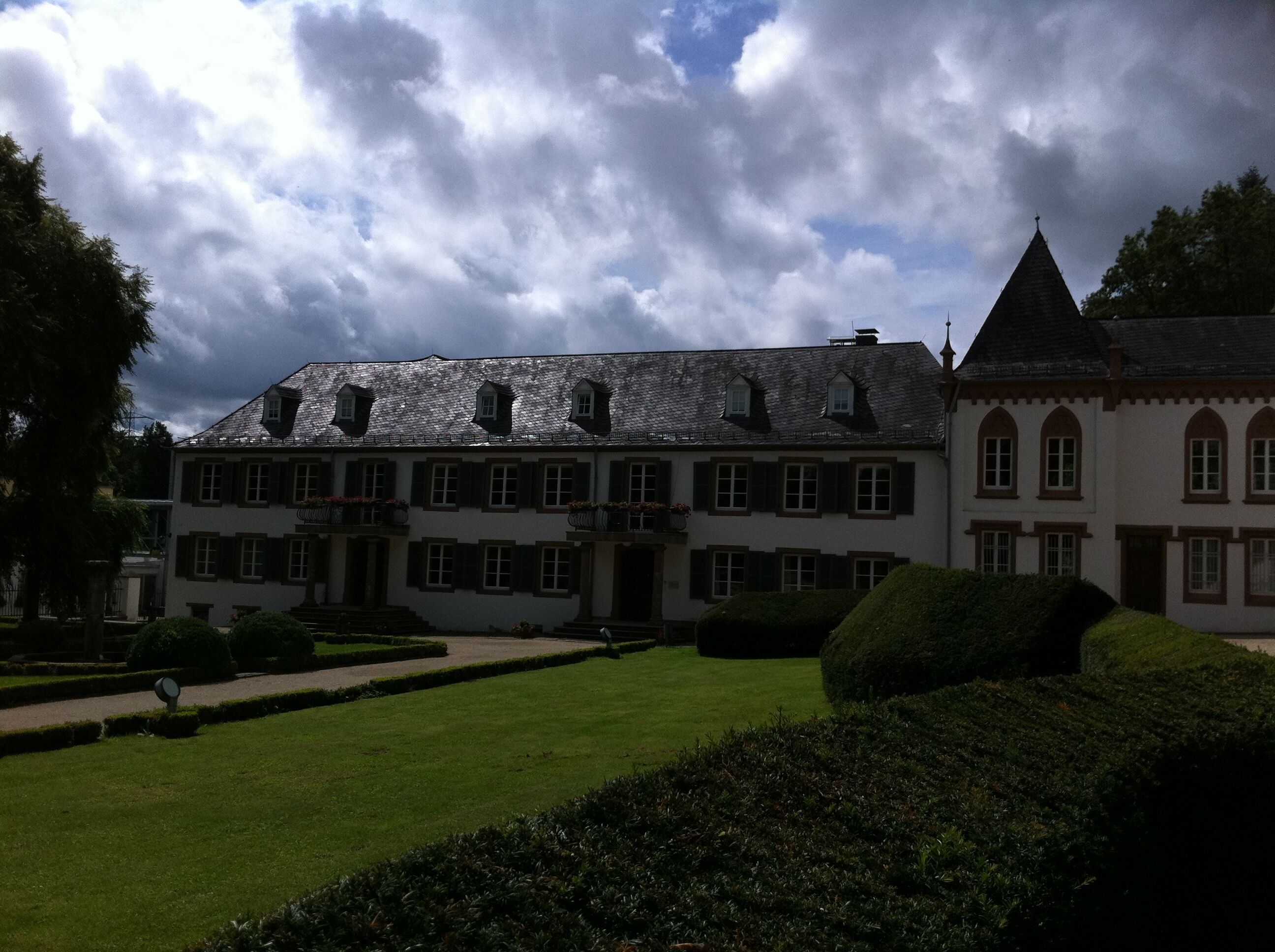 A large, historic building with multiple windows and a prominent tower.