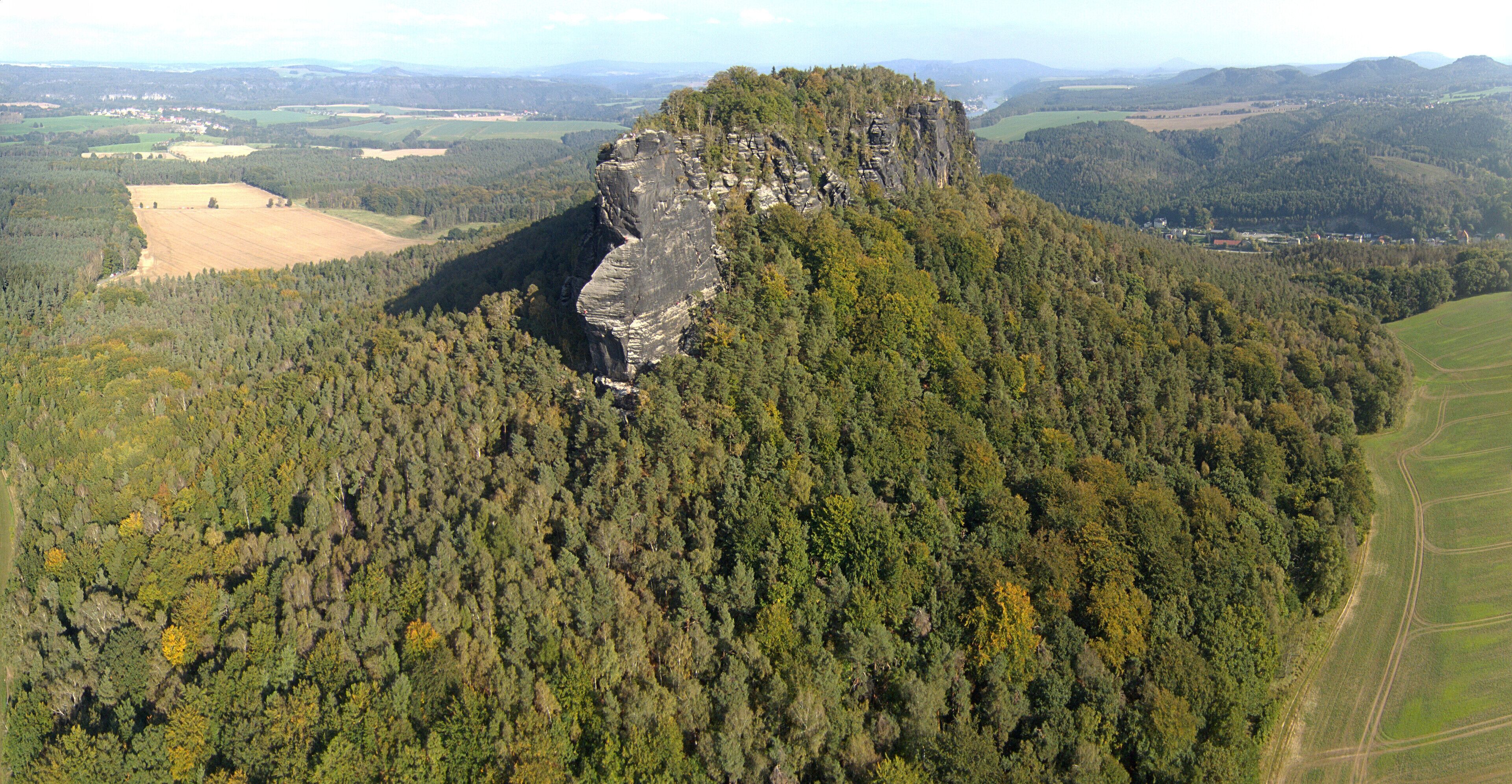 Aerial picture of one of the few table mountains on the east of the river Elbe called Lilienstein in Saxon Switzerland, in Saxony, southeastern Germany which constitutes the symbol of the Saxon Switzerland National Park; climbers are visible while climbing the mountain.