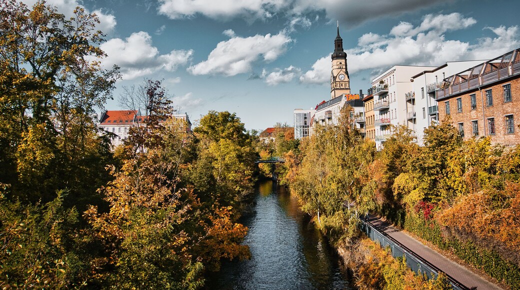 River runs through the town,
Embraced by autumnal trees and a church that rises majestically in the light.