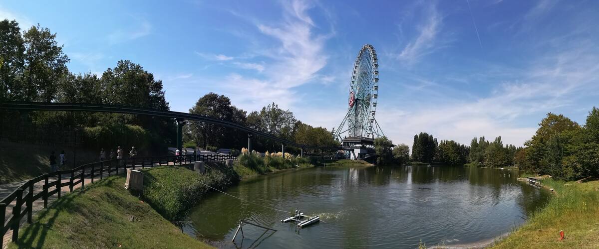 A Ferris wheel, a river, and a bridge.