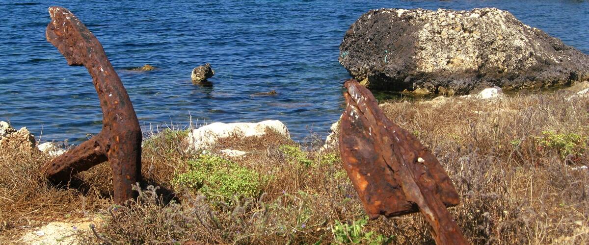 Rusty anchors on the coast of Valderice, Sicily