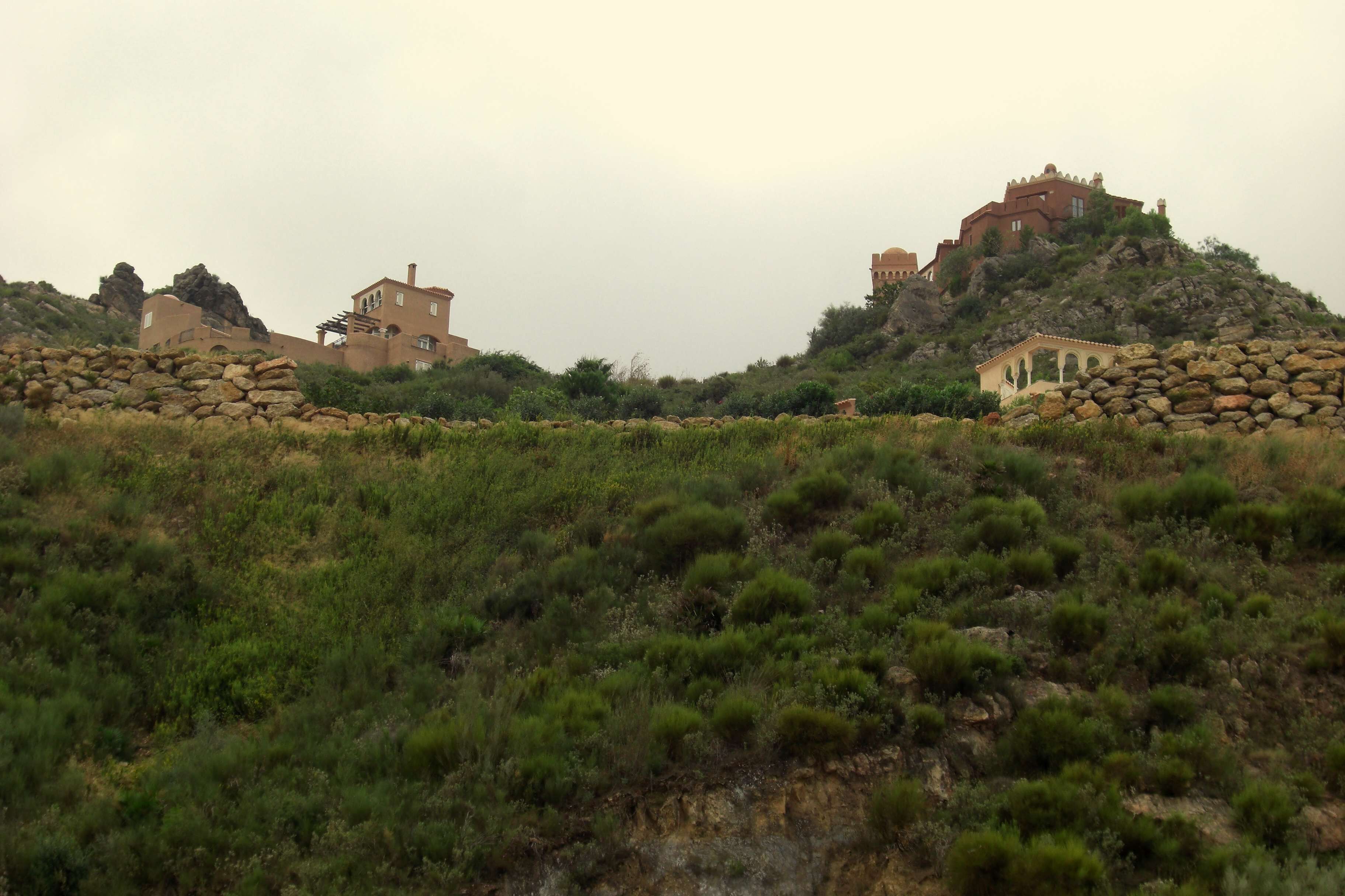 A hillside with ancient stone structures and buildings.