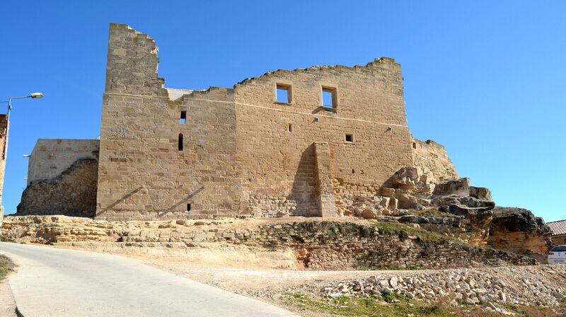 A historical stone building with visible windows and a staircase.