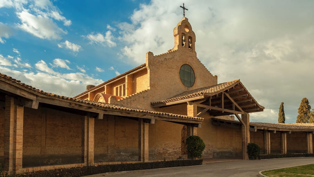 A church with a bell tower and a large circular window.