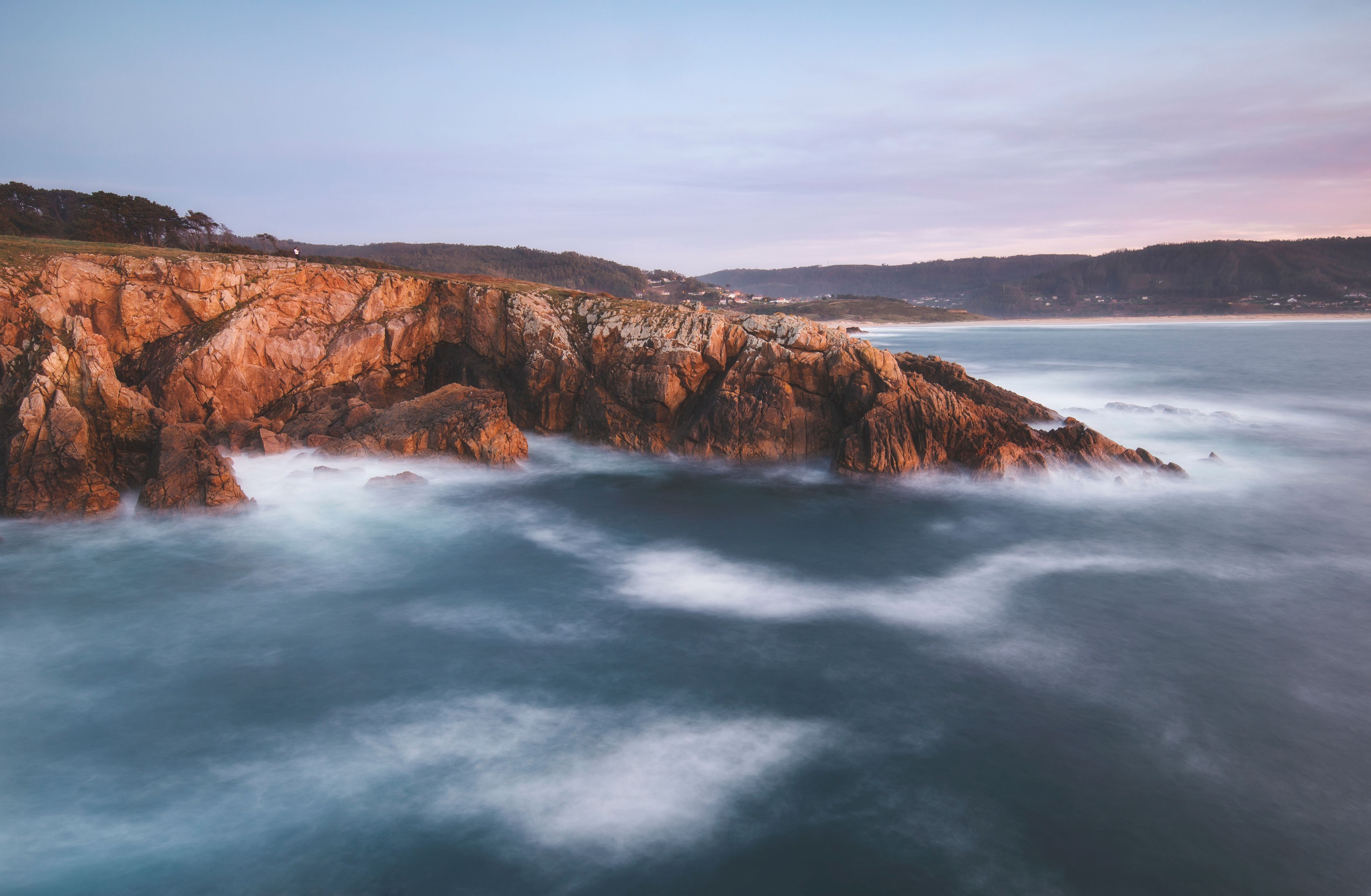 Scenic view of rocky coastline during sunset