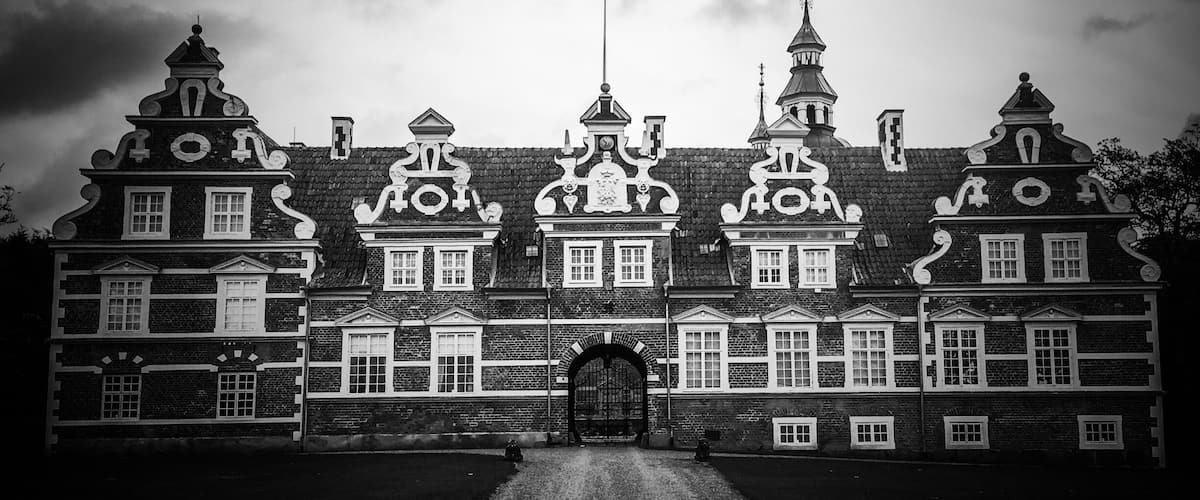 A historic building with ornate architecture, including multiple gables and a central clock tower.