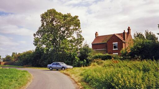 Former Station House at Fockerby. View SE: my Honda Accord waits by the north side of the former station, which was the terminus of the branch from Reedness Junction, Isle of Axholme Light Railway (NE & L&Y Joint), which last saw passengers on 17/7/33, goods 5/4/65.