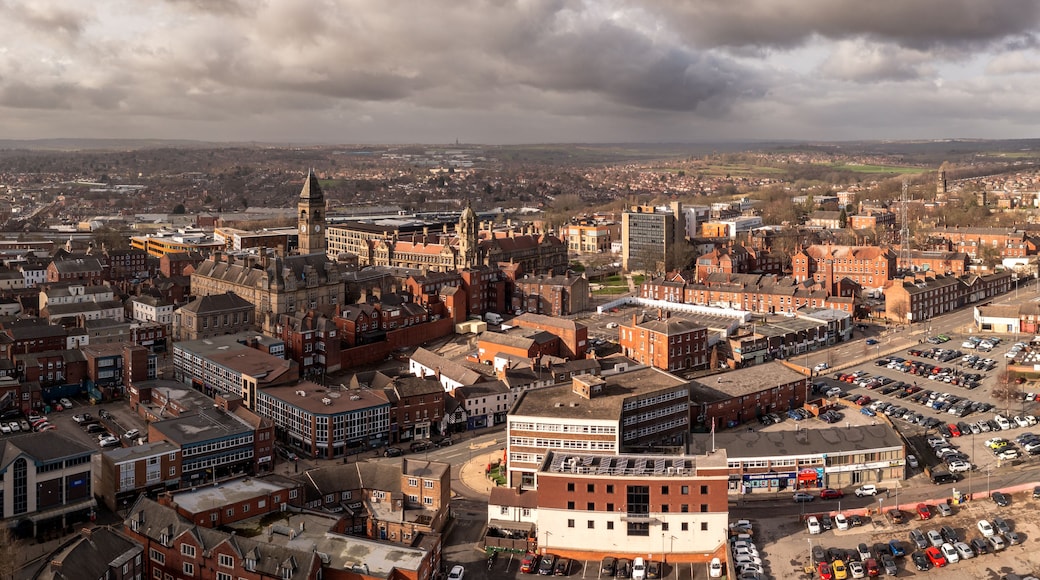 A cityscape with historic buildings, a prominent clock tower, and a mix of modern and traditional architecture.