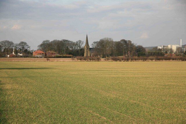 Across the fields to Amcotts Amcotts village in the distance with the church standing out in the afternoon sun.