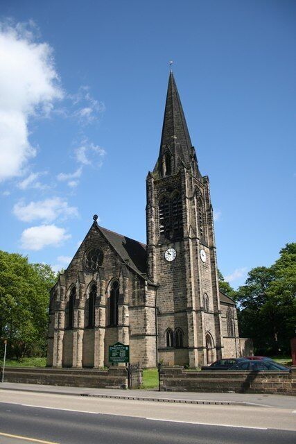 A church with a tall steeple and two clocks.