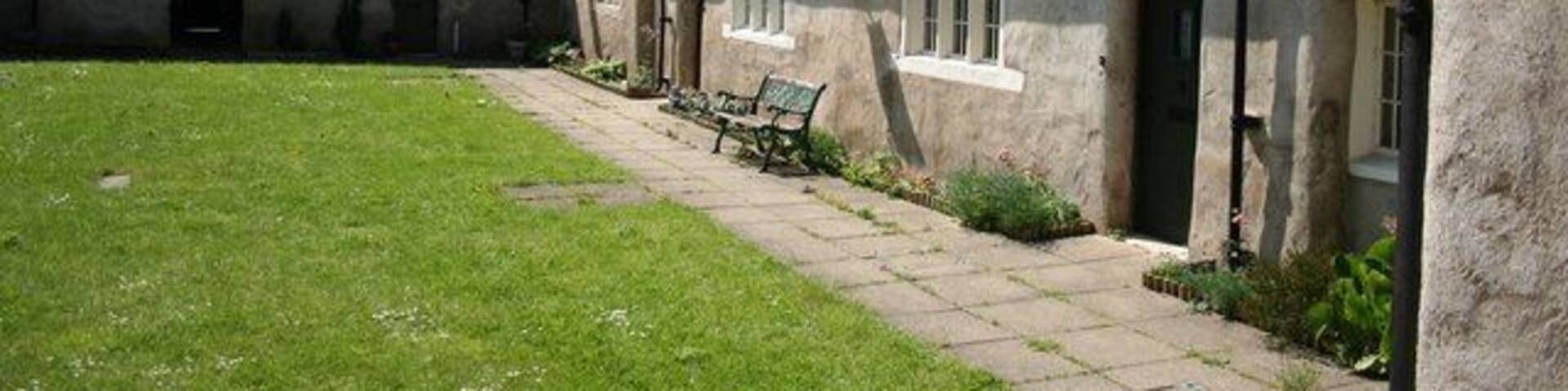 Almshouses Dating from 1660, a neat courtyard of cottages by the church