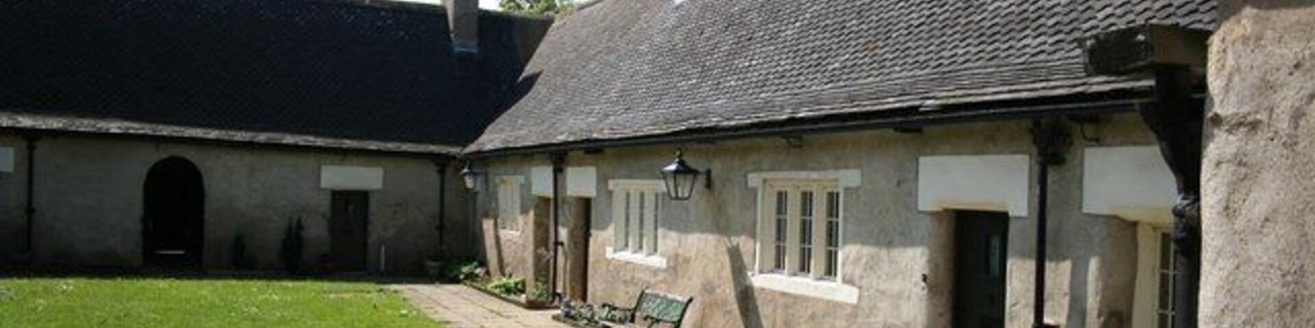 Almshouses Dating from 1660, a neat courtyard of cottages by the church