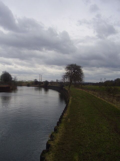 On the thin strip of land between river and canal.