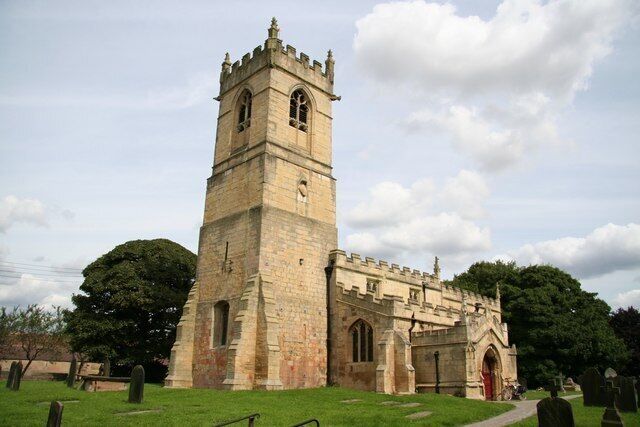 St.Peter's church Norman tower with 15th century top and crenelation all round