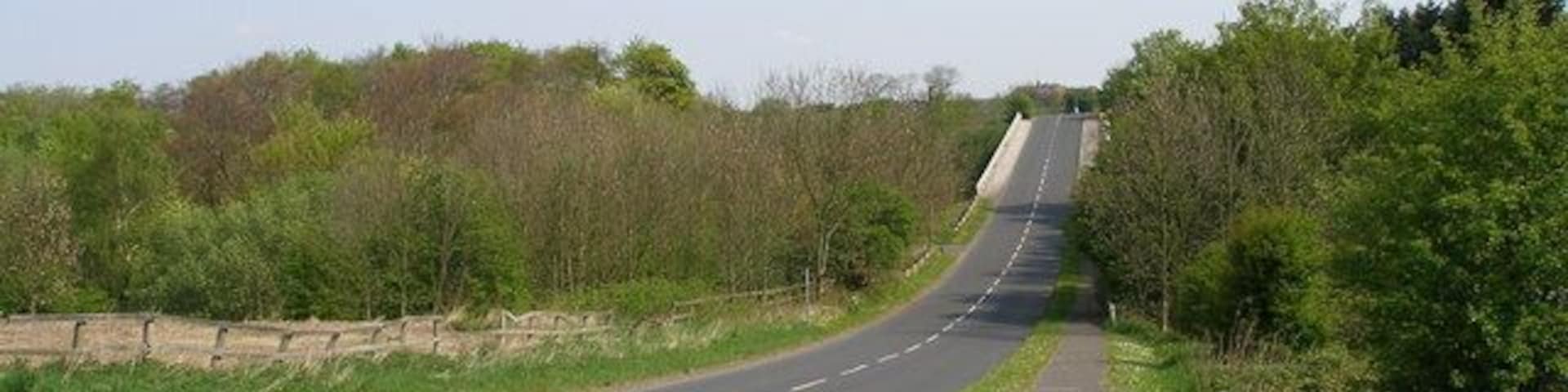 Pilley Lane This quiet road cut through lovely countryside. The white edges to the lane at the top of the picture are the bridge parapet as it passes over the M1.