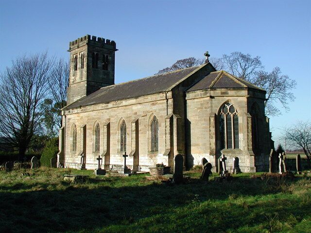 Holy Trinity Church, Blacktoft, East Riding of Yorkshire, England. Looking northwest across the churchyard from behind The Cottage on Blacktoft Lane.