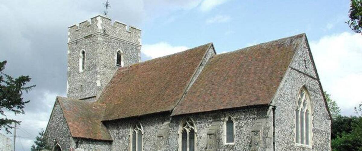 A stone church with a tower and arched windows.