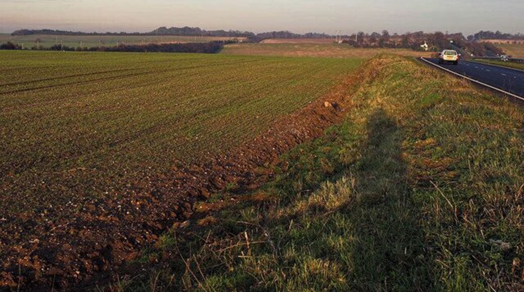 Between Modes The field shown, lies between the A505 (right) and the Hitchin to Cambridge railway line (left). The colour of the earth and sky is picked out by the low sun of the late afternoon.