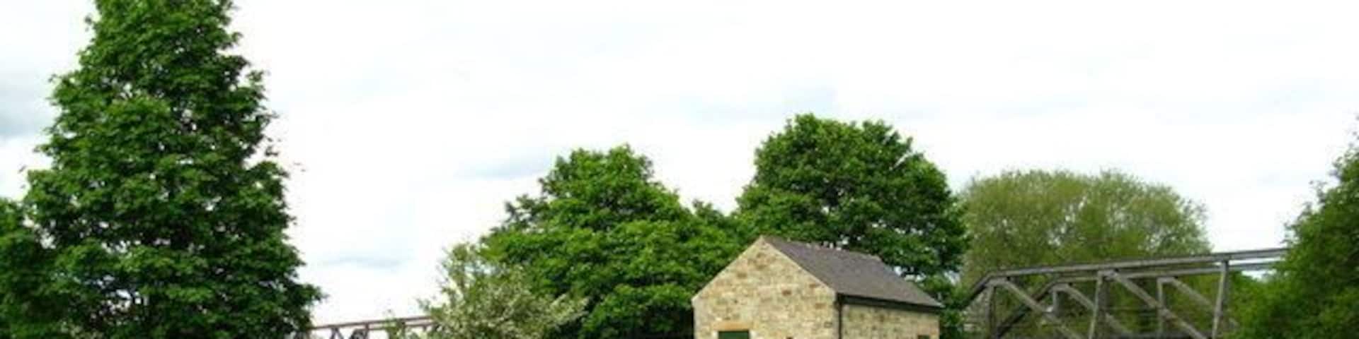 Catterick Bridge Flow Gauging Station on the banks of the Swale. The girder bridge in the background used to carry the Catterick Garrison Railway over the river.