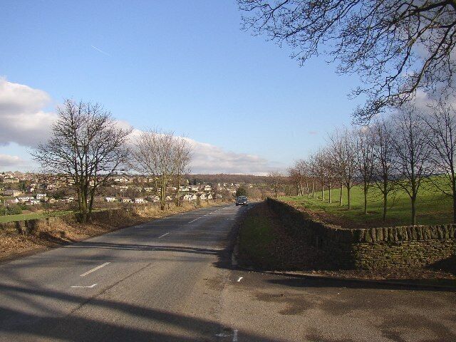 Woodsome Road, Farnley Tyas, Yorkshire. This view is looking eastwards from the entrance to Woodsome Hall. It is 'Road' not 'Lane' and has been constructed with an even gradient and a gentle curve, all signs that it is a diversion of an old lane that went through the estate. This is confirmed by reference to Jefferys's map of 1771, which shows the road as passing close by the hall and entering Farnely Tyas village via Field Lane. The new road is shown on the OS map of 1850.