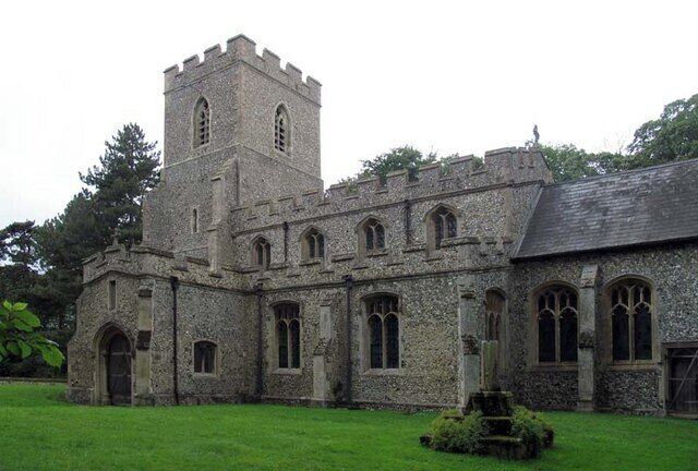 A historic stone building with a tower and arched windows.