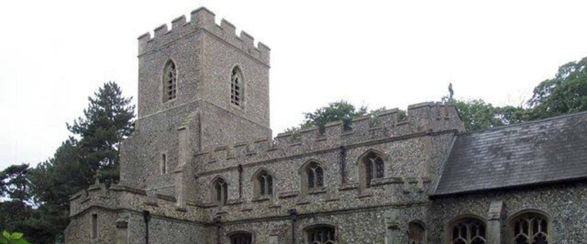 A historic stone building with a tower and arched windows.