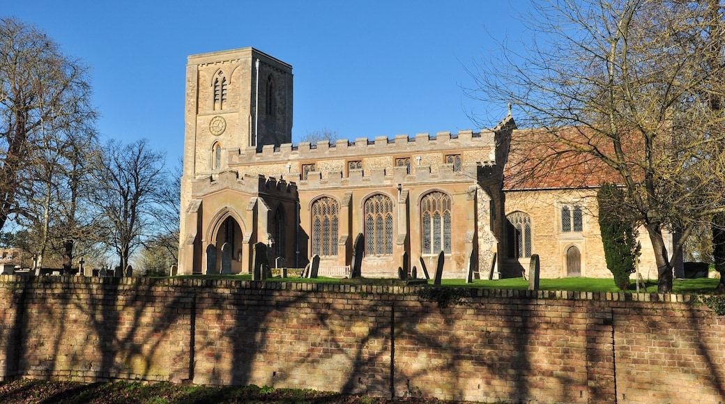 A historic church with a tall bell tower and arched windows.